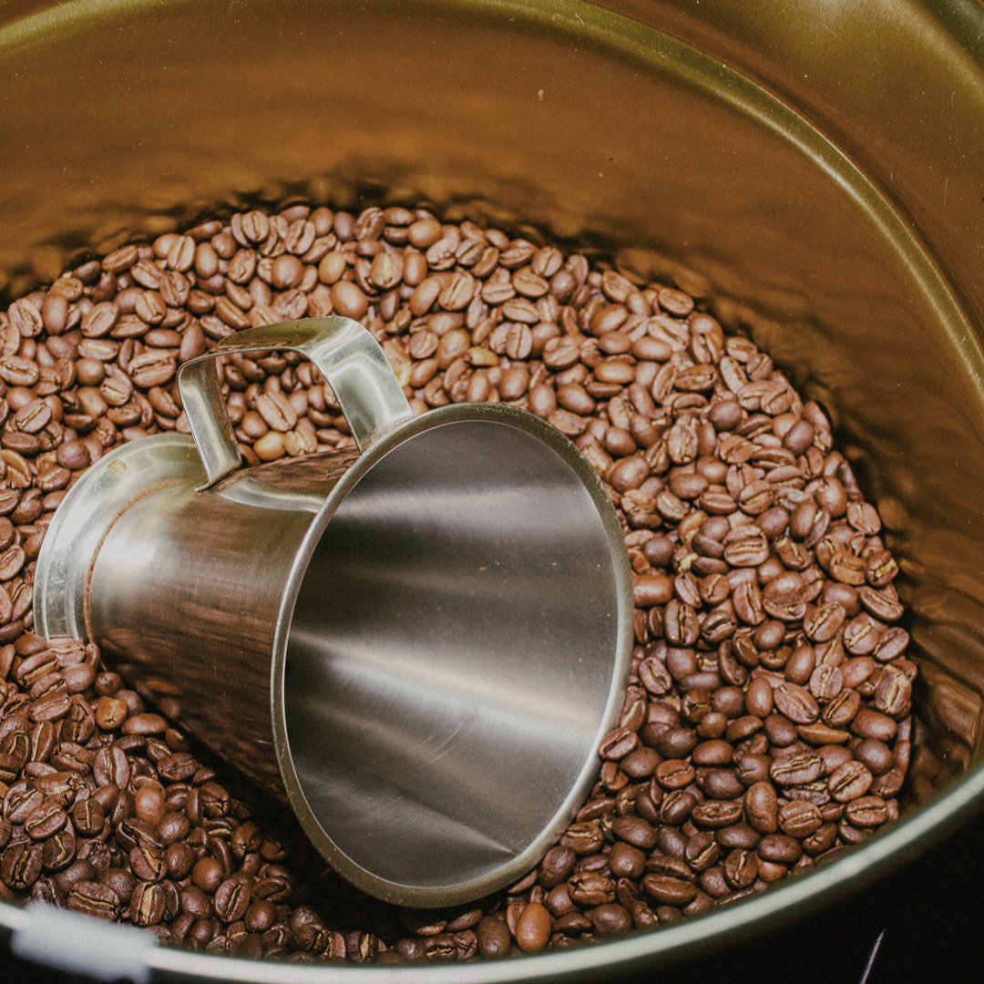 gold tin with grouch roasted coffee beans and a silver coffee scoop